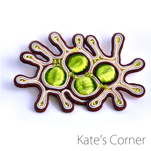 Green and beige brooch